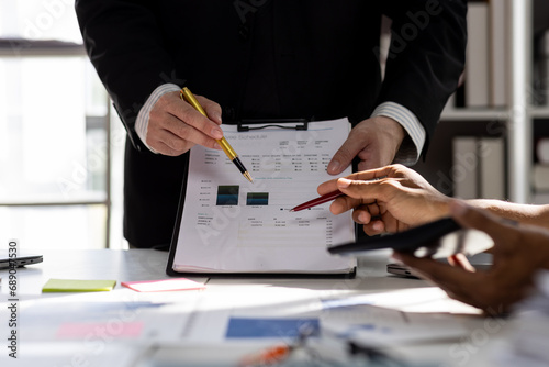 Close up Team of colleagues discussing business Accounting using calculating income-expenditure and calculator analyzing real estate investment data report Financial and tax systems concept.