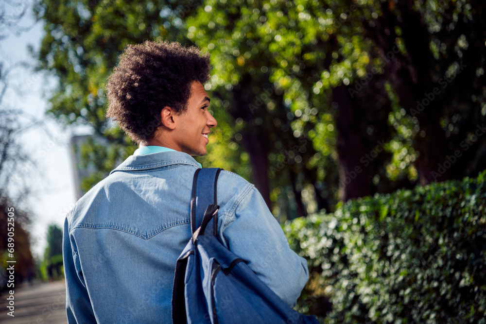 Photo of good mood funky guy dressed jeans shirt walking university studies outdoors urban city park Photo of good mood funky guy dressed jeans shirt walking university studies outdoors urban city park