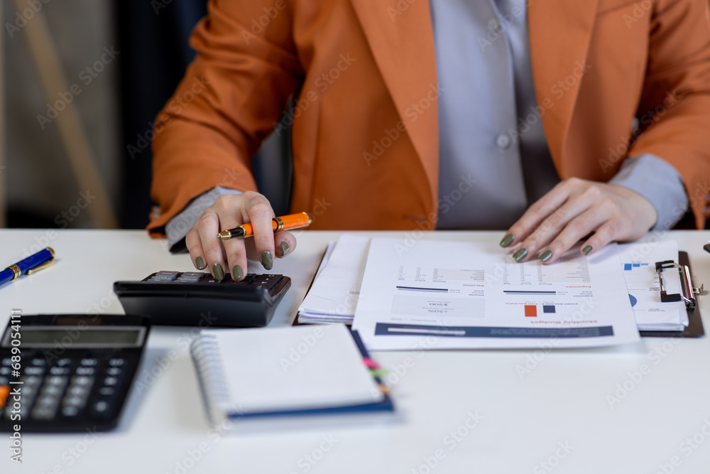 Business woman working at office with documents on his desk, doing planning analyzing the financial report, business plan investment, finance analysis concept Business woman working at office with documents on his desk, doing planning analyzing the financial report, business plan investment, finance analysis concept