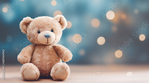 Toy bear on blue bokeh background with copy space.