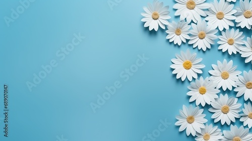 Flower border frame made of white and blue Daisy flowers on blue background. Seamless Greeting floral card template with copy space