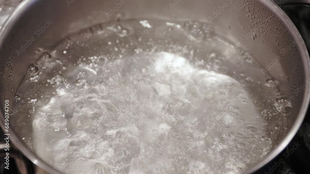 Close up of boiling water in pot - slow motion Close up of boiling water in pot - slow motion