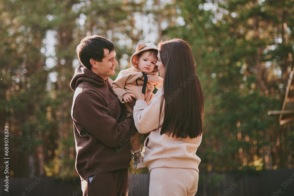 Portrait happy family mom dad and son having fun and enjoying spending time together in autumn park on sunny day. Love and loyalty, young parents Portrait happy family mom dad and son having fun and enjoying spending time together in autumn park on sunny day. Love and loyalty, young parents