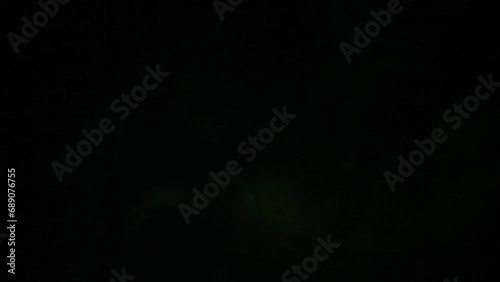 footage of green smoke dark background