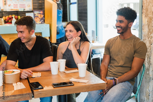 Happy friends enjoying time together in restaurant