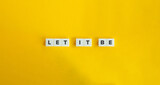 Let It Be Phrase on Block Letter Tiles on Yellow Background. Minimalist Aesthetics.