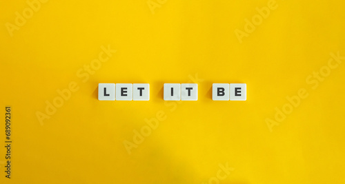 Bild auf Leinwand Let It Be Phrase on Block Letter Tiles on Yellow Background