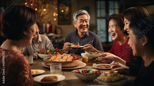 Happy, cheerful Asian people, one family sitting around same party table celebrating Lunar New Year. photo