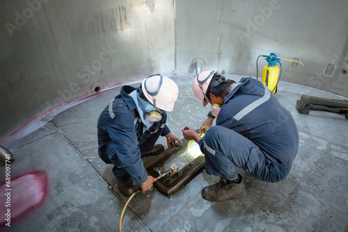 Male worker inspection vacuum test weld tank stainless steel
