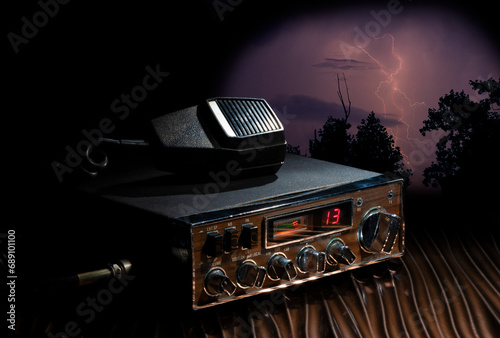 CB radio ready to transmit on channel 14 as a storm approaches with heavy lightning. photo