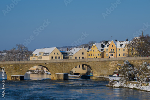 Stone bridge in Regensburg in the morning in winter with snow