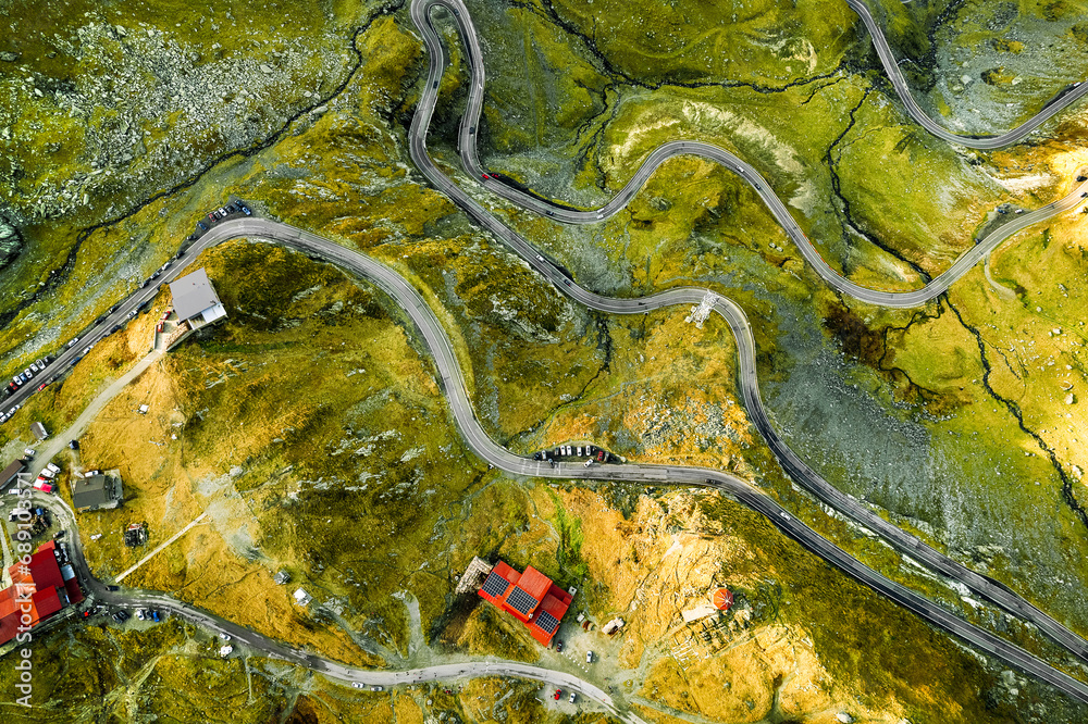 Aerial view of cabin by winding road in mountains Aerial view of cabin by winding road in mountains