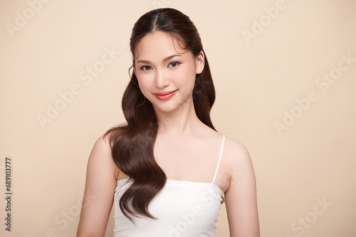 Beautiful young asian woman with clean fresh skin on beige background, Face care, Facial treatment, Cosmetology, beauty and spa, Asian women portrait.