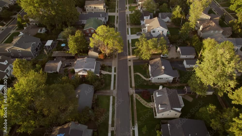 Aerial over nice suburban street with middle class houses at golden hour. Aerial over nice suburban street with middle class houses at golden hour.
