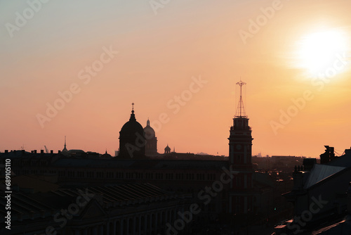 Panoramic view of the roofs, towers, domes of churches and cathedrals silhouetted against sunset light. Saint-Petersburg, Russia. Traveling and tourism concept. Copy space.