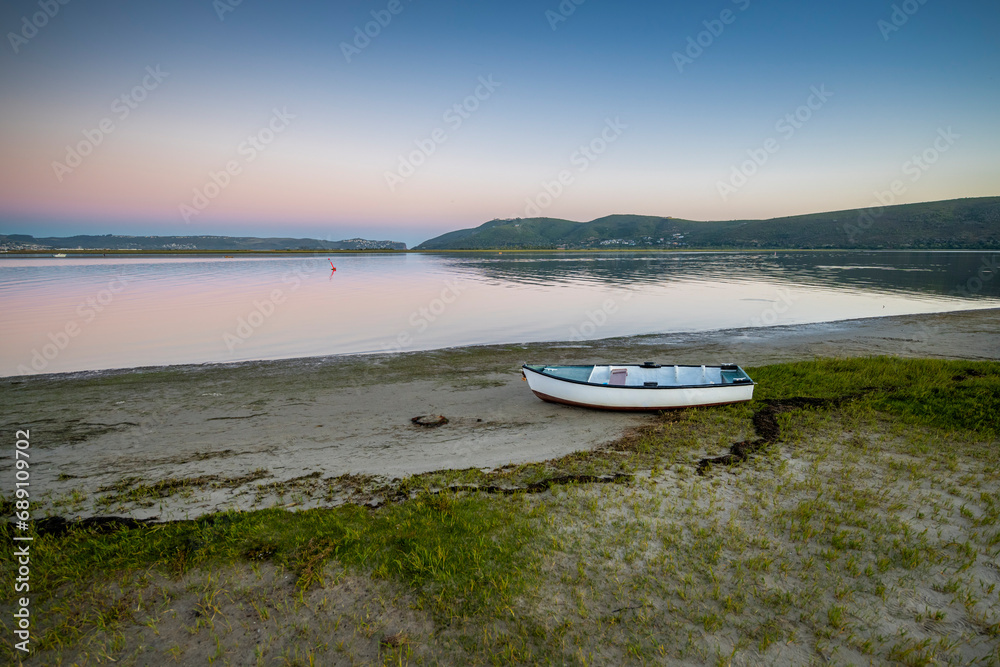 Knysna Lagoon with jetty and fishing boats at sunset in the Garden Route South Africa Knysna Lagoon with jetty and fishing boats at sunset in the Garden Route South Africa