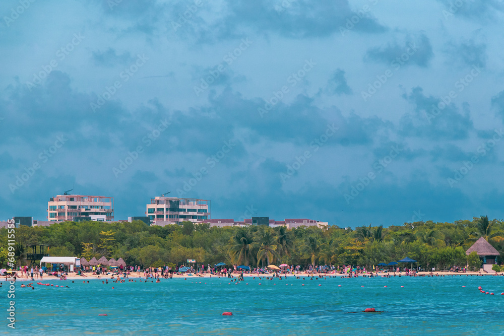 Obraz premium Tropical Caribbean beach people parasols fun Playa del Carmen Mexico.