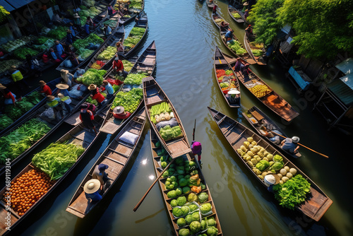 Aerial view famous floating market in Thailand. Floating market, Farmer go to sell organic products, fruits, vegetables and Thai cuisine, Tourists visiting by boat. © Bojan
