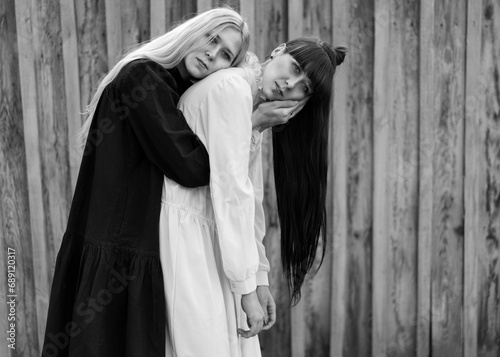 Fashion girls twins posing in nature