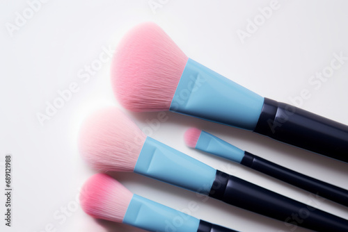 Set of diverse make up brushes in blue and pink on white background 