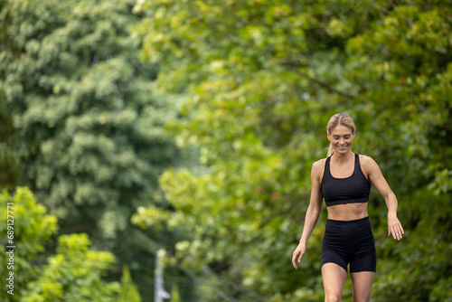 Woman running in summer park active sporty morning workout.