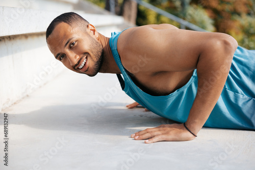 Sportsman doing push ups and looking concentrated