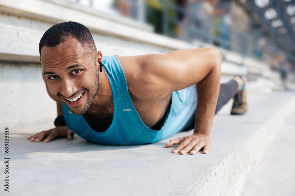 Man in blue tshirt exercising and doing push ups