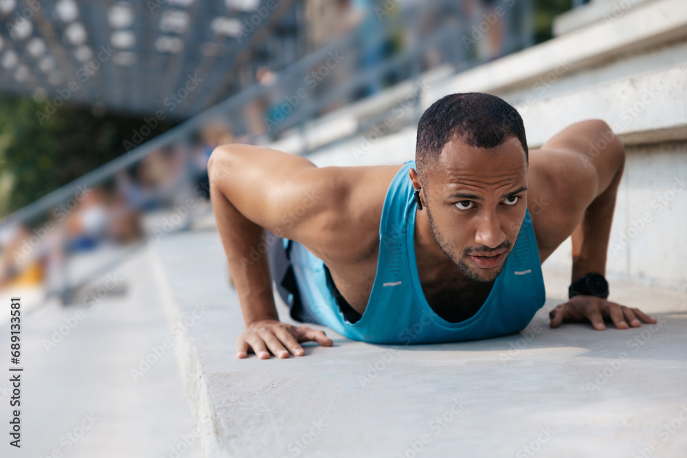 Man in blue tshirt exercising and doing push ups Man in blue tshirt exercising and doing push ups