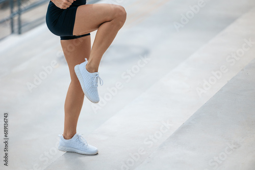Close up of an exercising female in black sports shorts © zinkevych