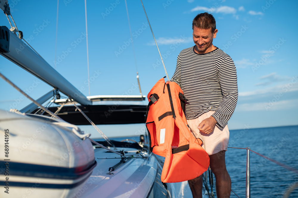 Man on a yacht smiling and feeling peaceful Man on a yacht smiling and feeling peaceful
