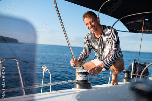 Man in a striped shirt sailing on a yacht © zinkevych