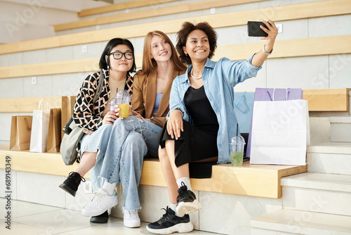 Valokuva Multiracial group of young women taking selfie relaxing at mall during shopping