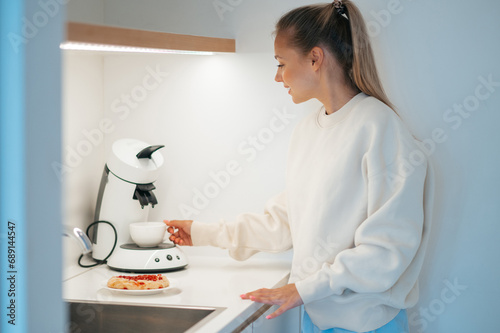 Girl in the kitchen preparing breakfast photo