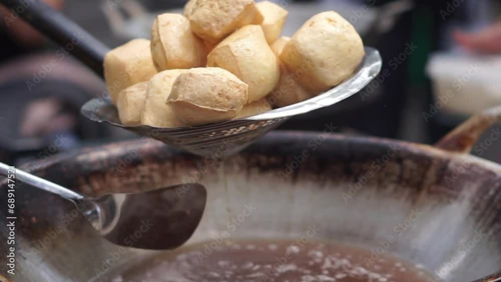 Street chef frying tofu in a wok over a blazing fire on a commercial stove, slow motion close up 4K Street chef frying tofu in a wok over a blazing fire on a commercial stove, slow motion close up 4K