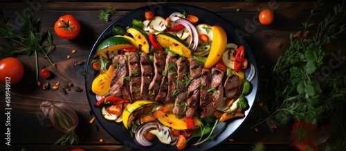 Grilled meat and vegetable salad with zucchini peaches green onions and peppers Overhead view on tiled background Copy space image Place for adding text or design
