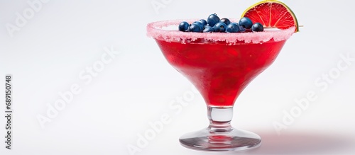 Patriotic cocktail with red pomegranate on white background rimmed in blue sugar perfect for July 4th Close up with space to copy Copy space image Place for adding text or design photo