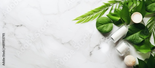 Organic skincare concept with green leaves and white stone background Copy space image Place for adding text or design photo