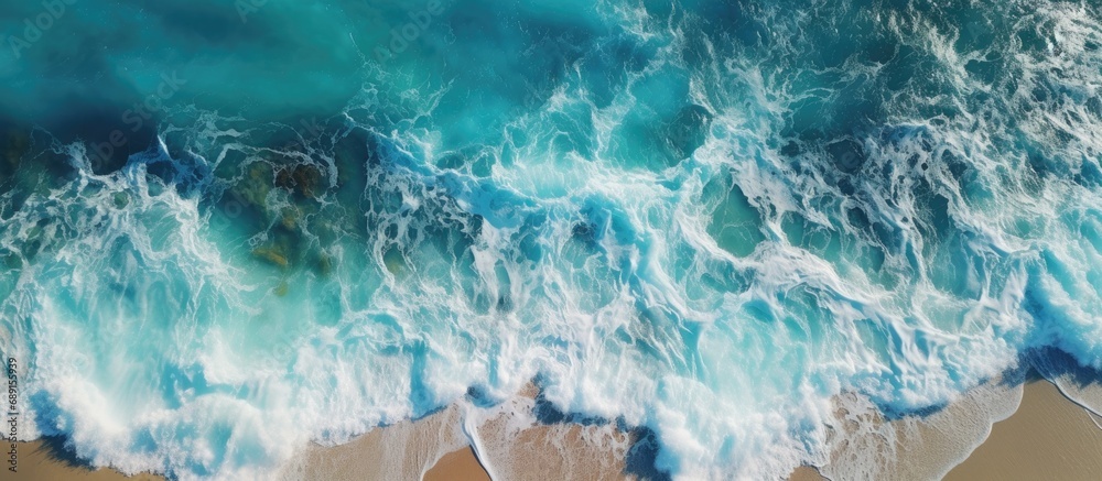 Fototapeta premium Ocean Beach drone video captures waves with rocks and foam Copy space image Place for adding text or design