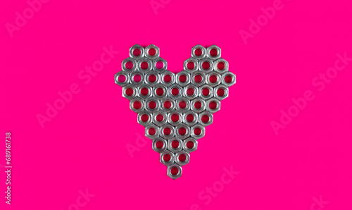 Heart from metal nuts on a pink background