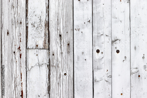 White old wood background. Old grungy and weathered white grey painted wooden wall plank texture background marked by long exposure to the elements outdoors and with paint peeling off.