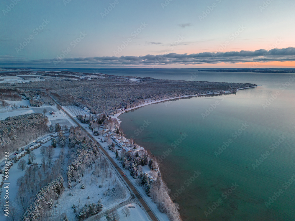 Winter's Serene Embrace: A Breathtaking Aerial View of Snow Covered Suttons Bay in Northern Michigan