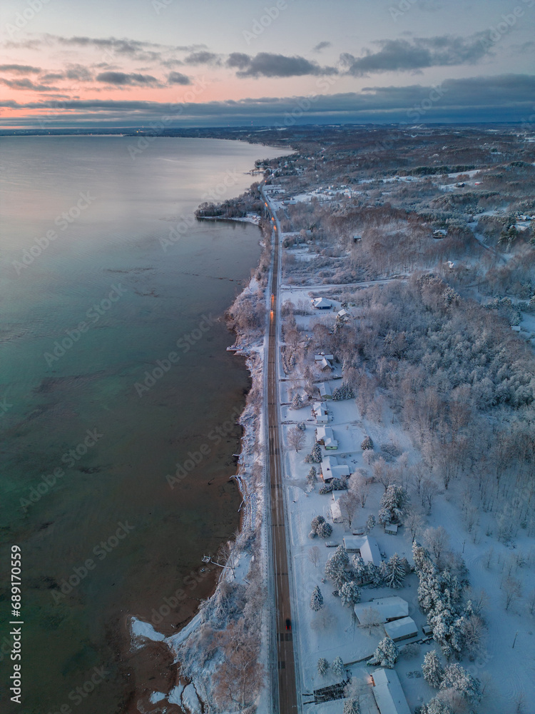 Winter's Serene Embrace: A Breathtaking Aerial View of Snow Covered Suttons Bay in Northern Michigan