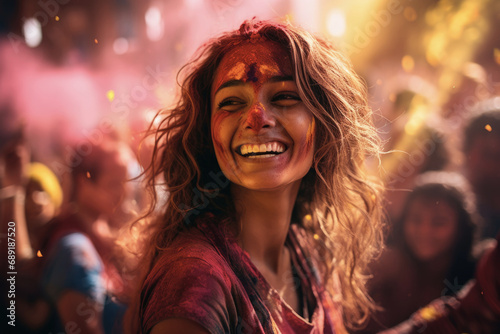 A smiling young Indian girl playing the Holi festival with colours 