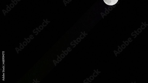 Moon Timelapse, Stock time lapse : Full moon rise in dark nature sky, night time. Full moon disk time lapse with moon light up in night dark black sky. High-quality free video footage or timelapse