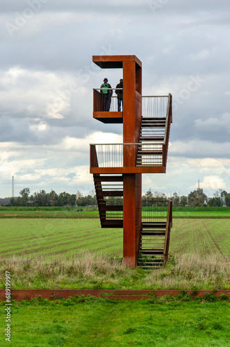 Zuidland, The Netherlands, October 8, 2023: corten steel observation tower overlooking the Beninger Slikken nature reserve and the adjacent polder photo
