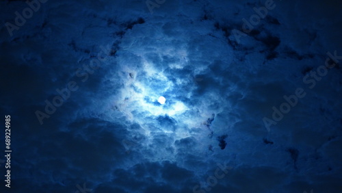 The moon night view with the full moon and clouds in the sky