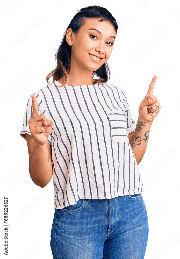 Young woman wearing casual clothes smiling confident pointing with fingers to different directions. copy space for advertisement Young woman wearing casual clothes smiling confident pointing with fingers to different directions. copy space for advertisement