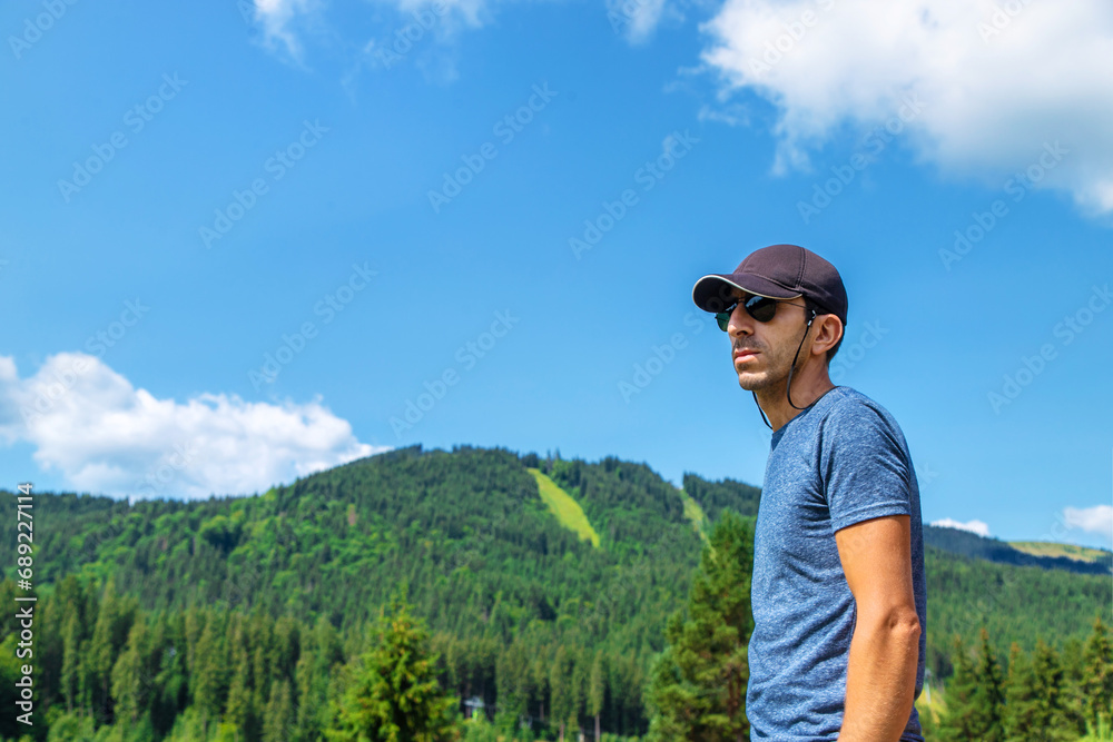 A man in the mountains looks. Selective focus. Selective focus.