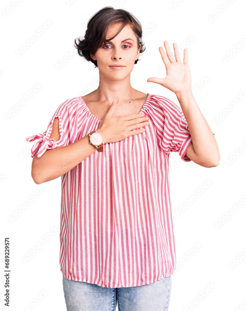 Beautiful young woman with short hair wearing casual summer clothes swearing with hand on chest and open palm, making a loyalty promise oath Beautiful young woman with short hair wearing casual summer clothes swearing with hand on chest and open palm, making a loyalty promise oath