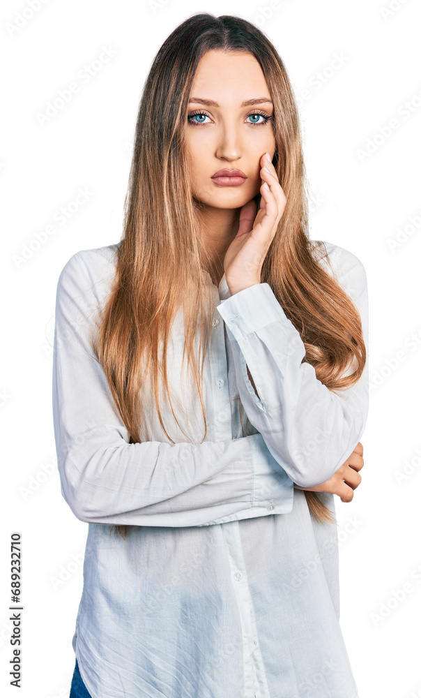 Beautiful caucasian woman wearing casual white shirt thinking looking tired and bored with depression problems with crossed arms. Beautiful caucasian woman wearing casual white shirt thinking looking tired and bored with depression problems with crossed arms.